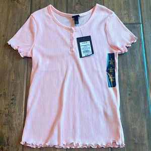 A pink short sleeve shirt soft, it has ruffles going along the outside shirt